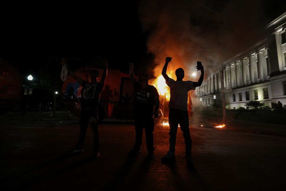 Protesters in response to the police shooting of Jacob Blake light a cleaning truck on fire in Kenosha, Wisconsin, on Aug. 24