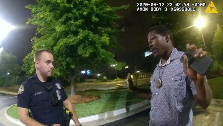 Rayshard Brooks (right) being questioned by Garrett Rolfe (right) outside of a Wendy's in Atlanta on June 12. Shortly thereaf